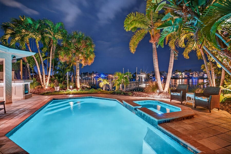 Pool and hot tub lit up at night