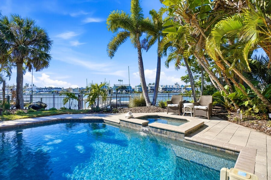 Heated pool with palms and water views